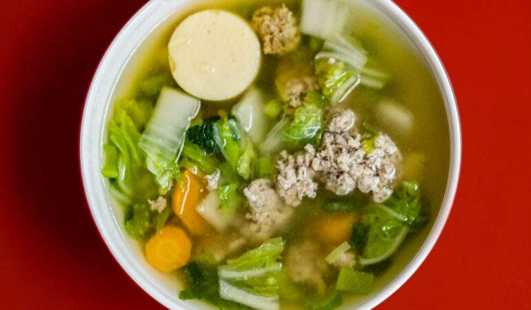 stew with meat and vegetables placed in white ceramic bowl